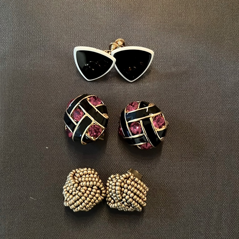 Three sets of clip on earrings.